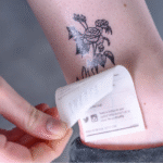Peeling off floral temporary tattoo paper
