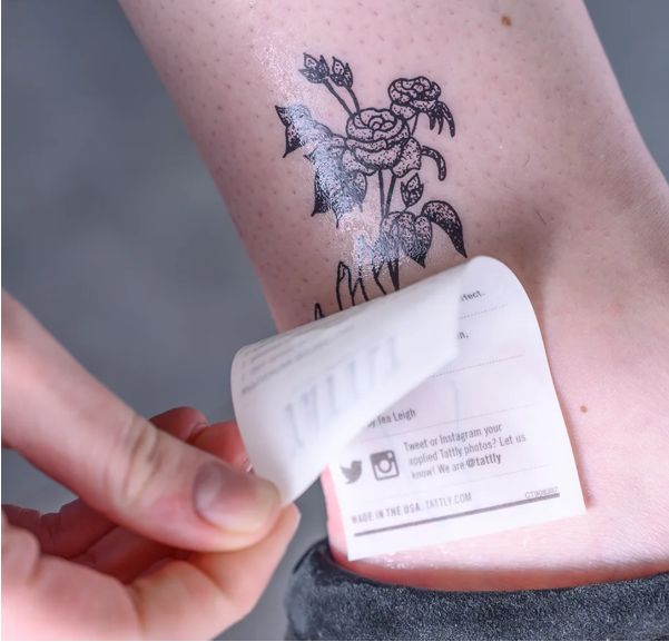 Peeling off floral temporary tattoo paper