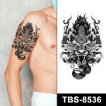 Black dragon mask tattoo on arm